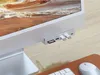 A close-up shot of a Satechi USB-C hub attached to an iMac, with USB drives and an SD card inserted. Produktbild-Vorschau