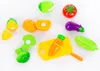 A collection of toy vegetables and a cutting board arranged on a white background. Náhled obrázku produktu