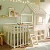 A child's bedroom with a white house-shaped loft bed, decorated with string lights. Náhľad obrázku produktu