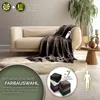 A plush heated blanket draped over a sofa in a living room setting, with marketing text and color swatches. Produktbild-Vorschau
