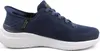 A side view of a navy blue Skechers slip-on sneaker with a white sole. Náhľad obrázku produktu