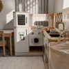 A child's play kitchen set up in a room with natural light. Podgląd zdjęcia produktu