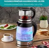 A glass electric kettle with a tea infuser on top, filled with water and illuminated by blue LEDs, sits on a wooden table next to a plate of food and a cup of tea. Anteprima dell’immagine prodotto