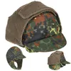 A camouflage winter hat with ear flaps and a brim, shown from multiple angles against a white background. Produktbild-Vorschau