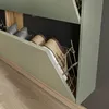 A close-up view of a shoe cabinet with shoes stored inside. Produktbild-Vorschau
