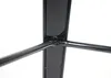 A close-up view of the black metal frame of a table, showing a joint where two support bars connect to a central vertical piece. Voir les images du produit
