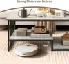 A modern coffee table with a robot vacuum cleaner underneath, in a living room setting. Produktbild-Vorschau
