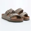 A pair of Birkenstock Arizona sandals in faded khaki. Produktbild-Vorschau