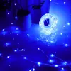 A coiled string of blue LED lights is shown on a white surface, with some of the lights spread out. Produktbild-Vorschau