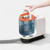A hand is holding the handle of a portable cleaning device. Náhled obrázku produktu