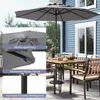 An outdoor patio scene with a table, chairs, and a large gray umbrella. Anteprima dell’immagine prodotto