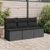 A three-seater outdoor sofa with black cushions sits on a paved patio, with a wooden fence and plants in the background. Voir les images du produit