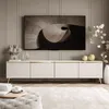 A modern living room with a TV cabinet and a large TV mounted on the wall. Náhled obrázku produktu