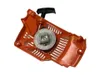 A close-up, angled view of a chainsaw starter assembly. Náhled obrázku produktu