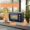 A mini oven is shown on a kitchen counter with text overlays indicating its dimensions and features. Podgląd zdjęcia produktu