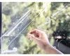 A hand is applying a clear protective film to a window pane, with bubbles visible on the film. Náhled obrázku produktu