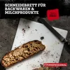 A slice of bread on a white cutting board with a knife, set against a dark, textured background. Text overlays provide product information. Produktbild-Vorschau