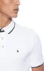 Close-up of a person wearing a white polo shirt. Produktbild-Vorschau