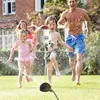 A family is playing in a garden with a sprinkler. Produktbild-Vorschau