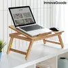 A laptop is placed on a wooden lap desk on a white table. Produktbild-Vorschau