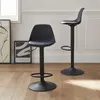 Two black bar stools are shown in a room with wooden floors and white walls. Produktbild-Vorschau