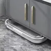 A close-up view of a gray cabinet with gold handles, and a white and gray foldable mop bucket placed underneath it on a marble-patterned floor. Podgląd zdjęcia produktu