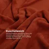 A close-up of a textured, rust-colored fabric, likely a blanket, with text overlaid. Náhled obrázku produktu