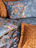 Close-up view of bedding with a floral leaf pattern. Produktbild-Vorschau