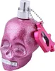 A pink glittery skull-shaped perfume bottle with a silver cap and a pink keychain accessory. Anteprima dell’immagine prodotto