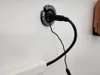 A close-up of a black power cord plugged into a wall outlet. Produktbild-Vorschau