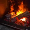 A close-up view of a fireplace with glowing logs and flames. Produktbild-Vorschau