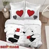 A bedding set with a teddy bear couple kissing design, displayed on a bed. Produktbild-Vorschau