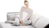 A woman sitting on a sofa holding a pillow. Produktbild-Vorschau