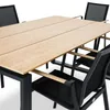 A close-up shot of a wooden and aluminum outdoor dining table with black chairs. Náhled obrázku produktu
