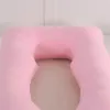 A pink U-shaped pregnancy pillow on a bed. Produktbild-Vorschau