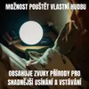 A person is reading in bed next to a bedside table with a lamp and a clock. Náhľad obrázku produktu