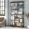 A tall, multi-shelf bookcase filled with decorative items and books, placed in a room with a window and a chair. Podgląd zdjęcia produktu