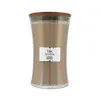 A WoodWick candle with a wooden lid and a label that reads "WoodWick" and "CASHMERE CACHEMIRE". Produktbild-Vorschau