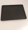 A black baking tray with a textured surface is placed on a white surface. Voir les images du produit