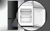 A black refrigerator with a close-up view of its interior drawers and freezer compartment. Produktbild-Vorschau
