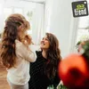A mother and daughter are decorating a Christmas tree. Produktbild-Vorschau