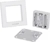 A white frame, a white device with battery compartments, and a white mounting plate are arranged on a white background. Produktbild-Vorschau