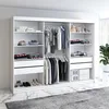 An open wardrobe with clothes and accessories neatly organized on shelves and hanging racks. Produktbild-Vorschau