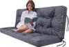 A woman is sitting on a gray cushion, reading a book. Anteprima dell’immagine prodotto