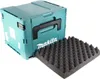 A teal Makita tool case with a black handle is shown next to a piece of black foam with a wavy texture. The case has the Makita logo on it. Produktbild-Vorschau