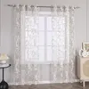 A window with sheer curtains is shown, with a side table and a cabinet visible. Produktbild-Vorschau