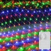 A net of colorful LED lights is draped over bushes and grass, suggesting outdoor decoration. Náhled obrázku produktu