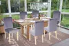 A dining room set with chairs around a table, set in a sunroom with a garden view. Voir les images du produit