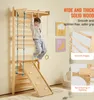A young boy is playing on a wooden indoor playground structure, which includes a climbing wall, ladder, and slide. The image also features marketing text and close-up shots of the wood's texture and edges. Podgląd zdjęcia produktu