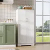 A kitchen scene with a white cabinet next to green cabinets and a large window with a view of nature. Náhľad obrázku produktu
